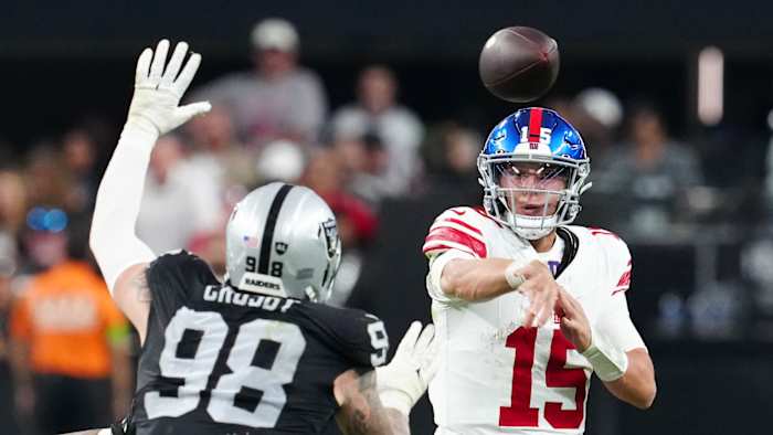 Nov 5, 2023; Paradise, Nevada, USA; New York Giants quarterback Tommy DeVito (15) is pressured by Las Vegas Raiders defensive end Maxx Crosby (98) during the fourth quarter at Allegiant Stadium.